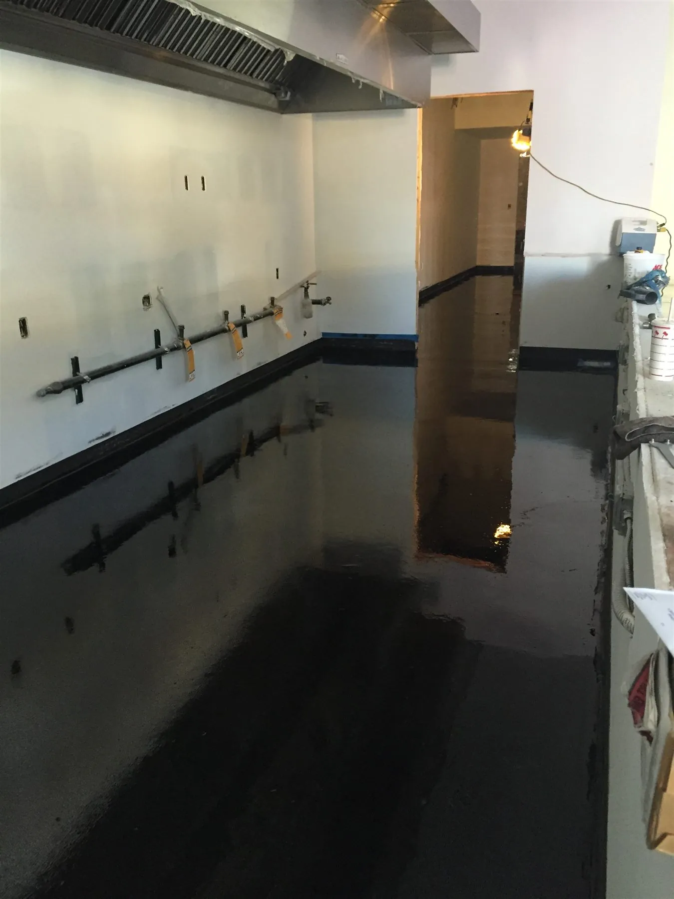 Black epoxy floor in a restaurant kitchen at Press Up Grill